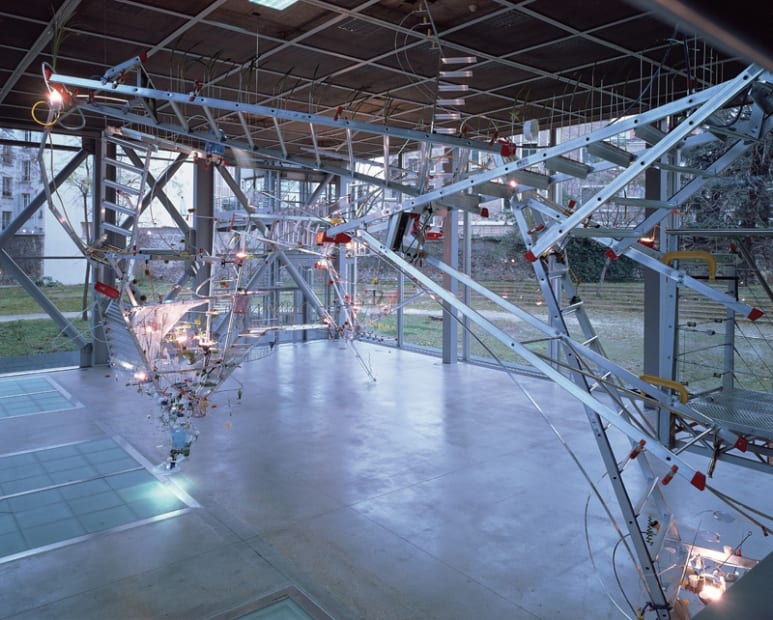 Image of Sarah Sze installation of ladders and other objects circling from ceiling to floor