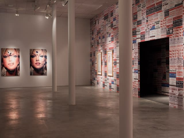 Installation view of Phil Collins wall posters and photographs