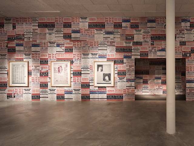 Installation view of Phil Collins wall posters and photographs