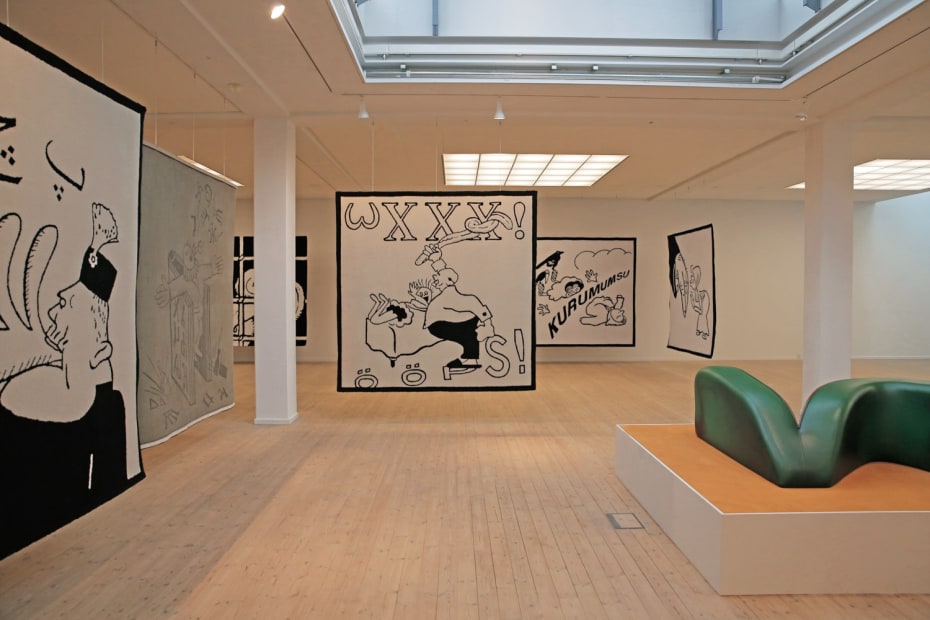 Image of an installation view of Slavs and Tatars - carpets hanging