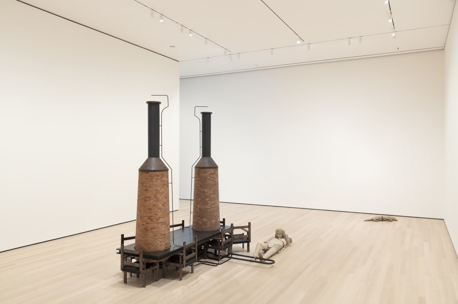 Image of Mark Manders installation, factory with clay figure and chair