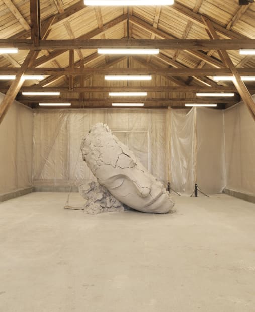 image of Mark Manders installation inside of barn, dry clay head sculpture
