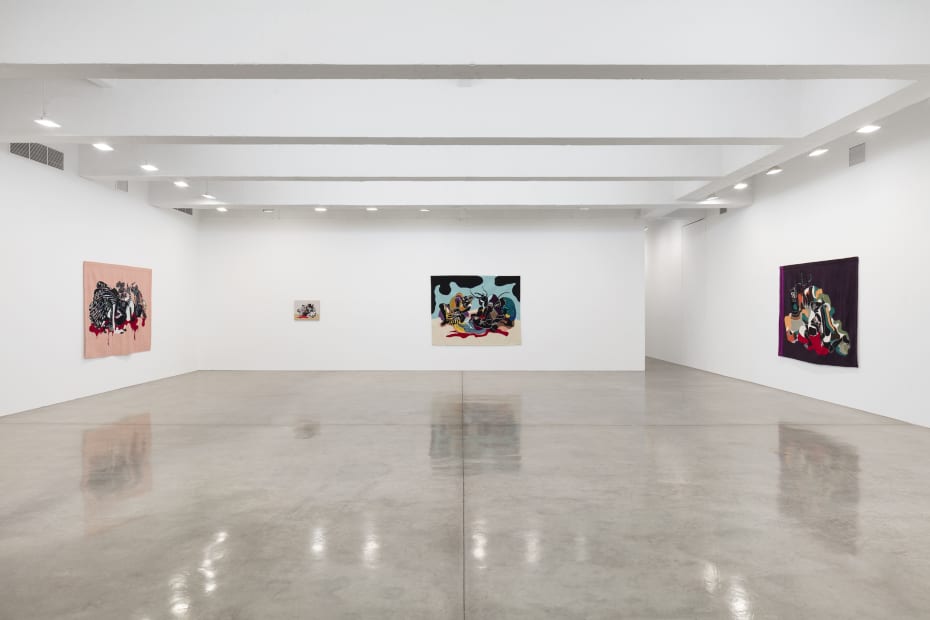 installation view of tapestries and paintings