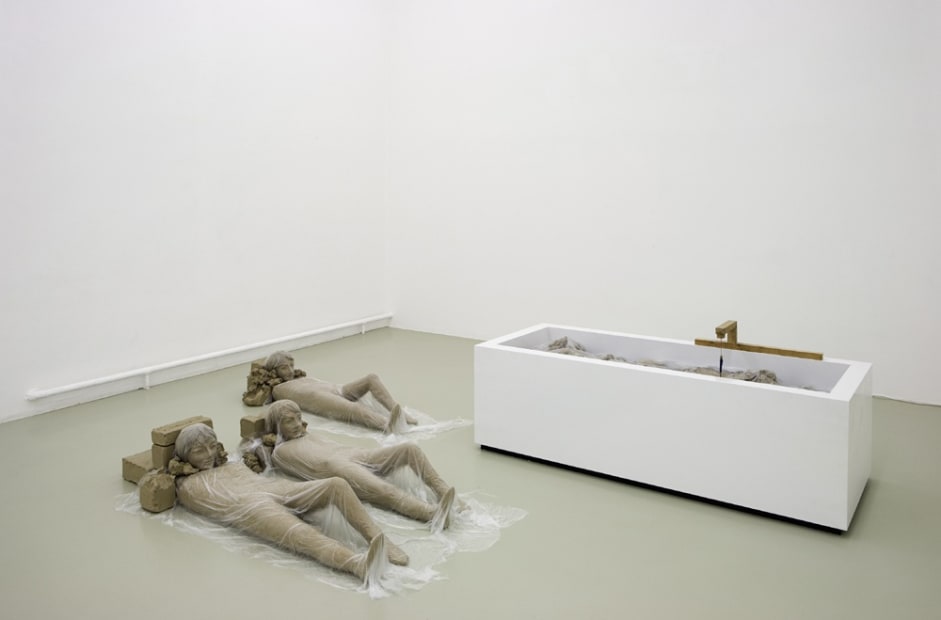 image of Mark Manders installation of sculptures on floor with plastic covering