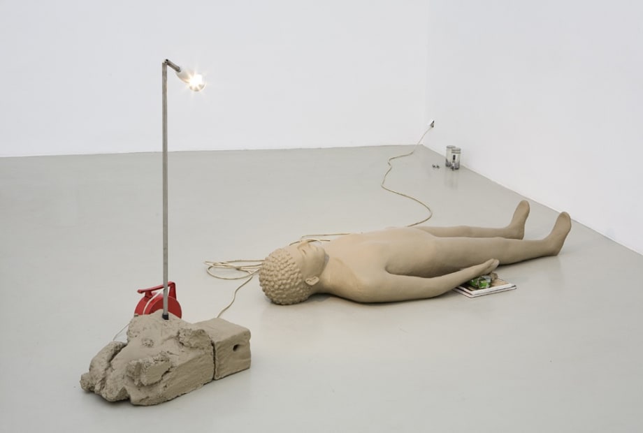 image of Mark Manders clay figure on floor with light