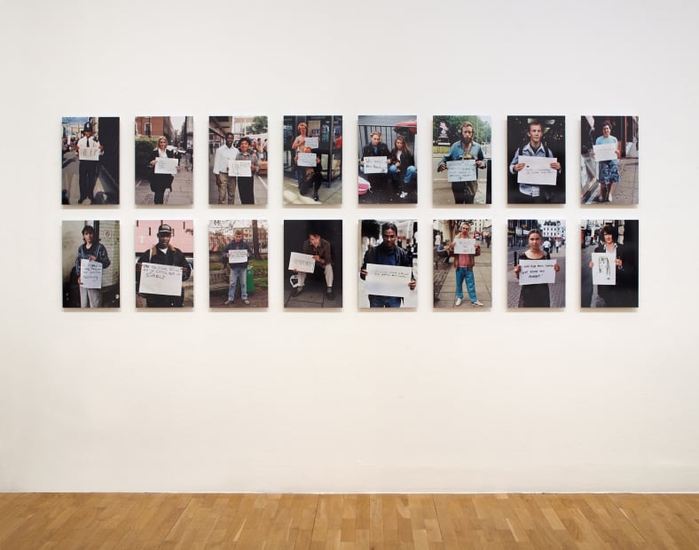 Installation view of Gillian Wearing at Whitechapel Gallery, London, photographs of people holding signs