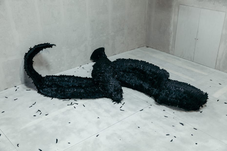 image of a sculpture of a large fallen black bird