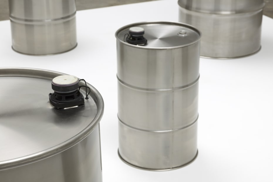 image of steel barrels on white pedestal
