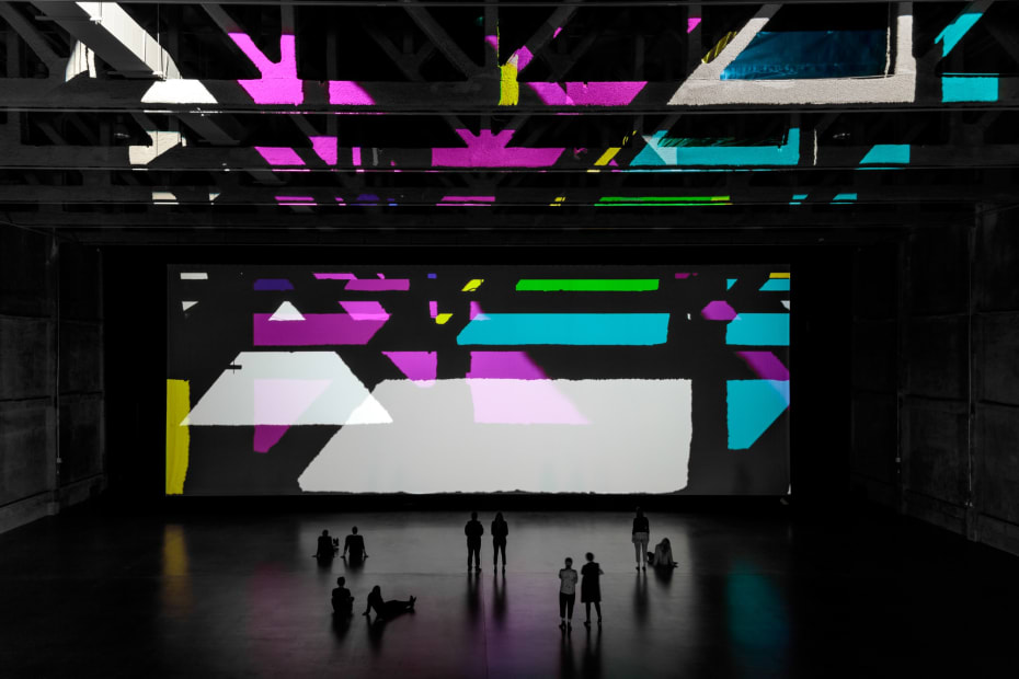 image of installation view large space with color filters and lights projecting onto the wall