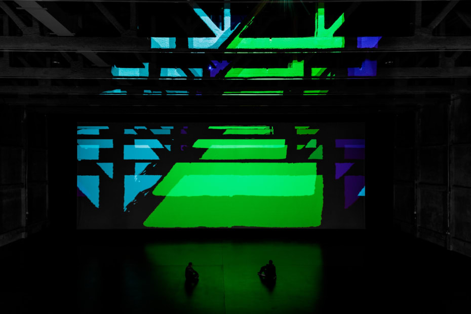 image of installation view large space with color filters and lights projecting onto the wall
