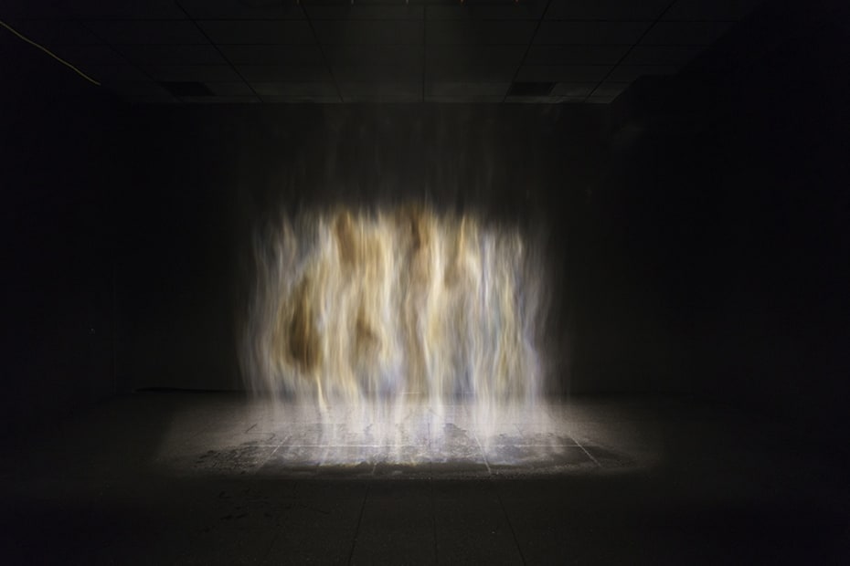 image of mist creating a rainbow in a dark room