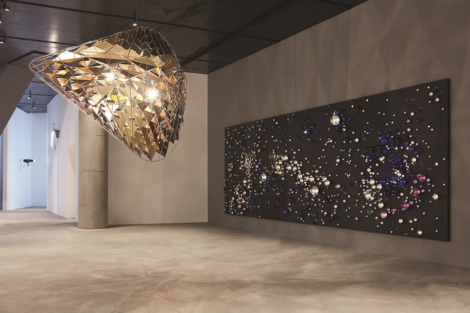 Installation image of Eliasson exhibition, walls with spheres and hanging light sculpture
