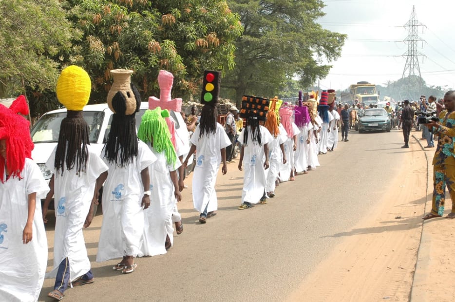 image of processional with people wearing large wigs