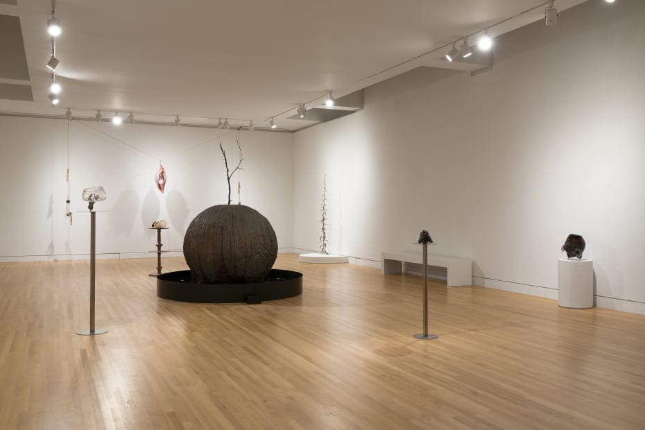 sculptures spaced out in a gallery with white walls and wood floor