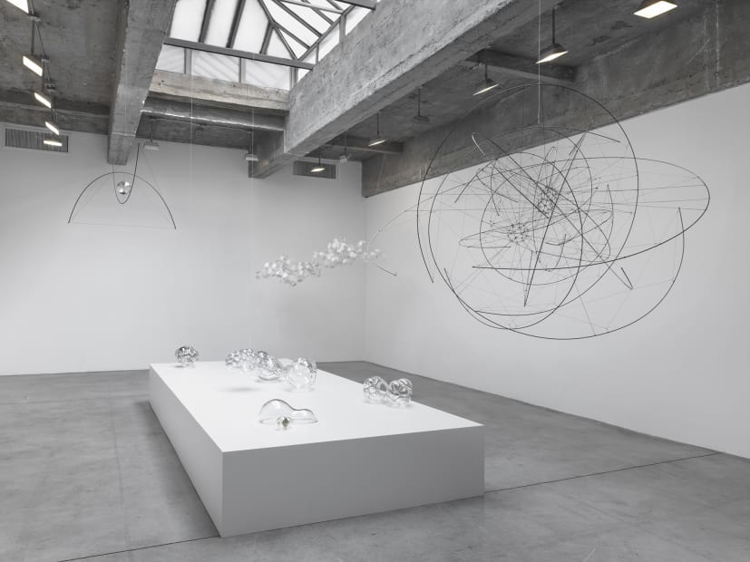 Saraceno glass objects on table and hanging sculptures