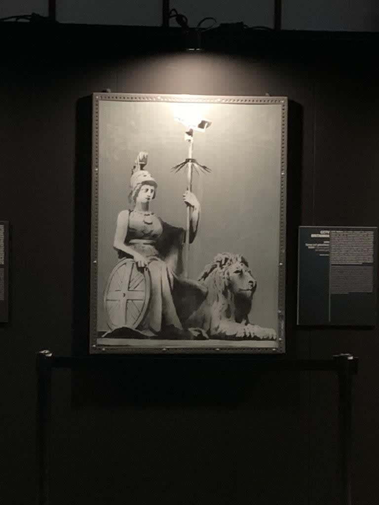 Banksy artwork hanging on wall