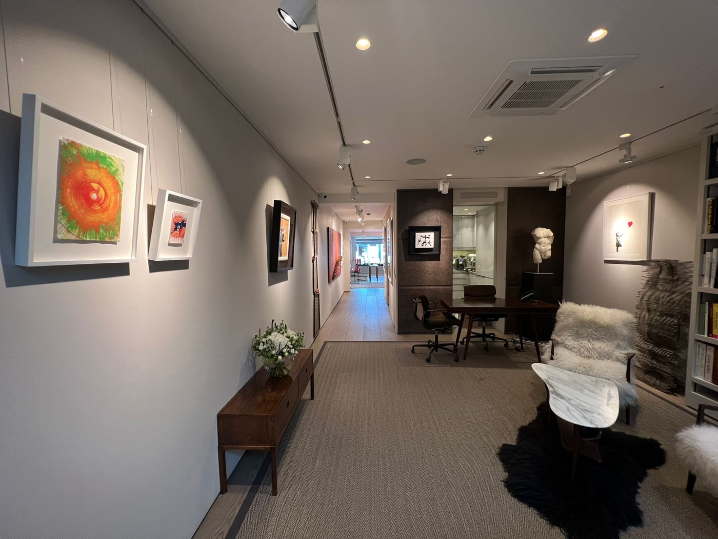 Exhibition view from the downstairs of Andipa Gallery. Artwork and tapestries hanging on the walls.