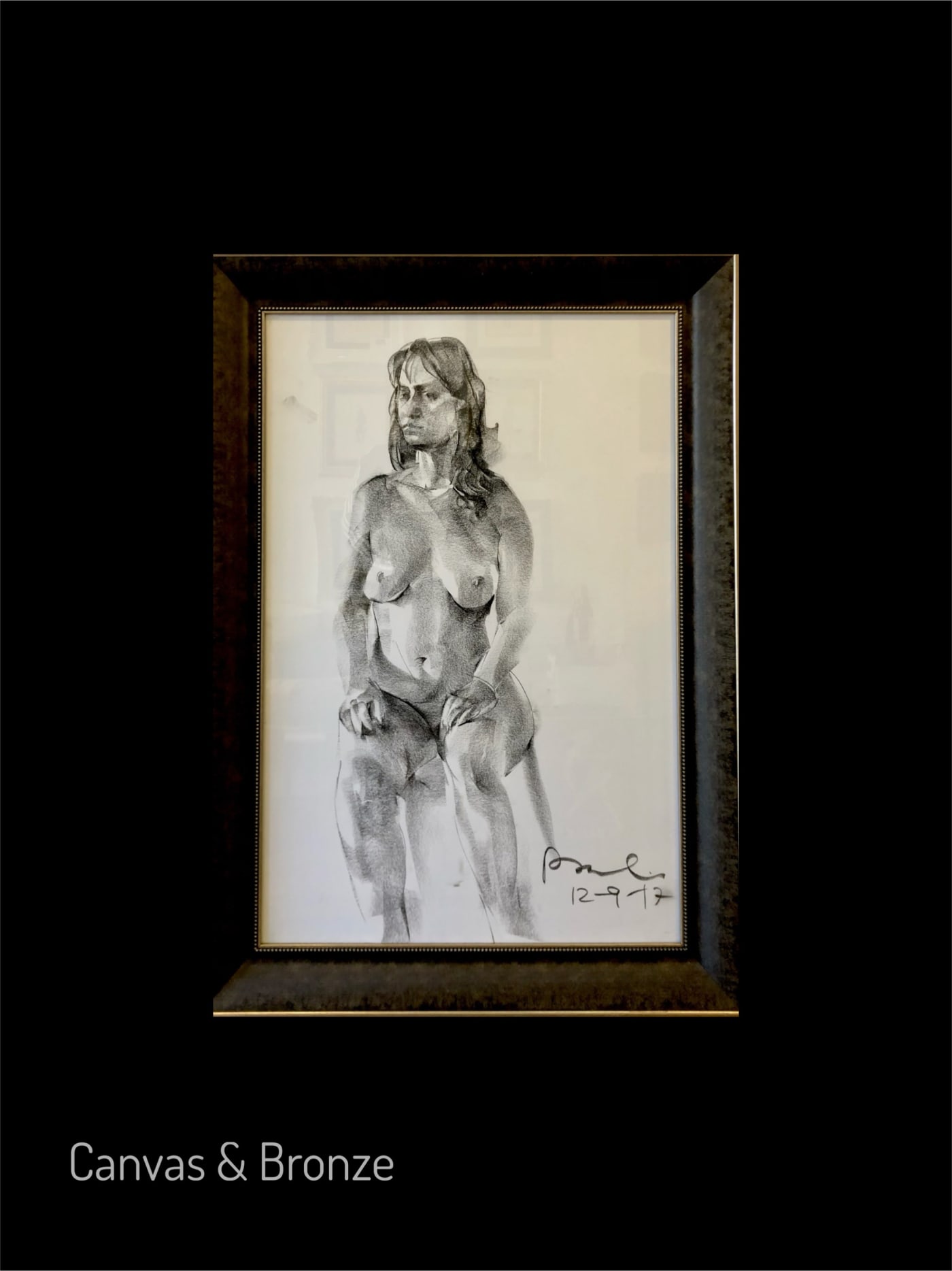 Black and white sketch of a seated nude woman, signed by the artist, framed in a simple black frame.