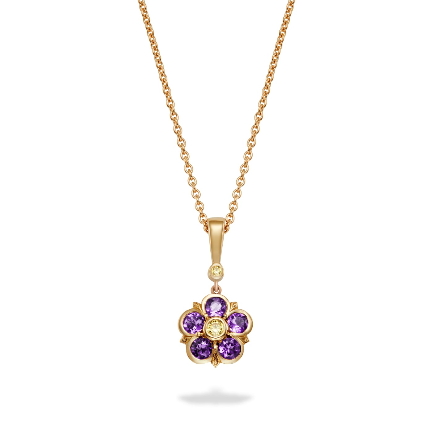 Amethyst and yellow diamond pendant in a floral setting set in 18k yellow gold, which hangs off a yellow diamond and bale from a chain. On a white background