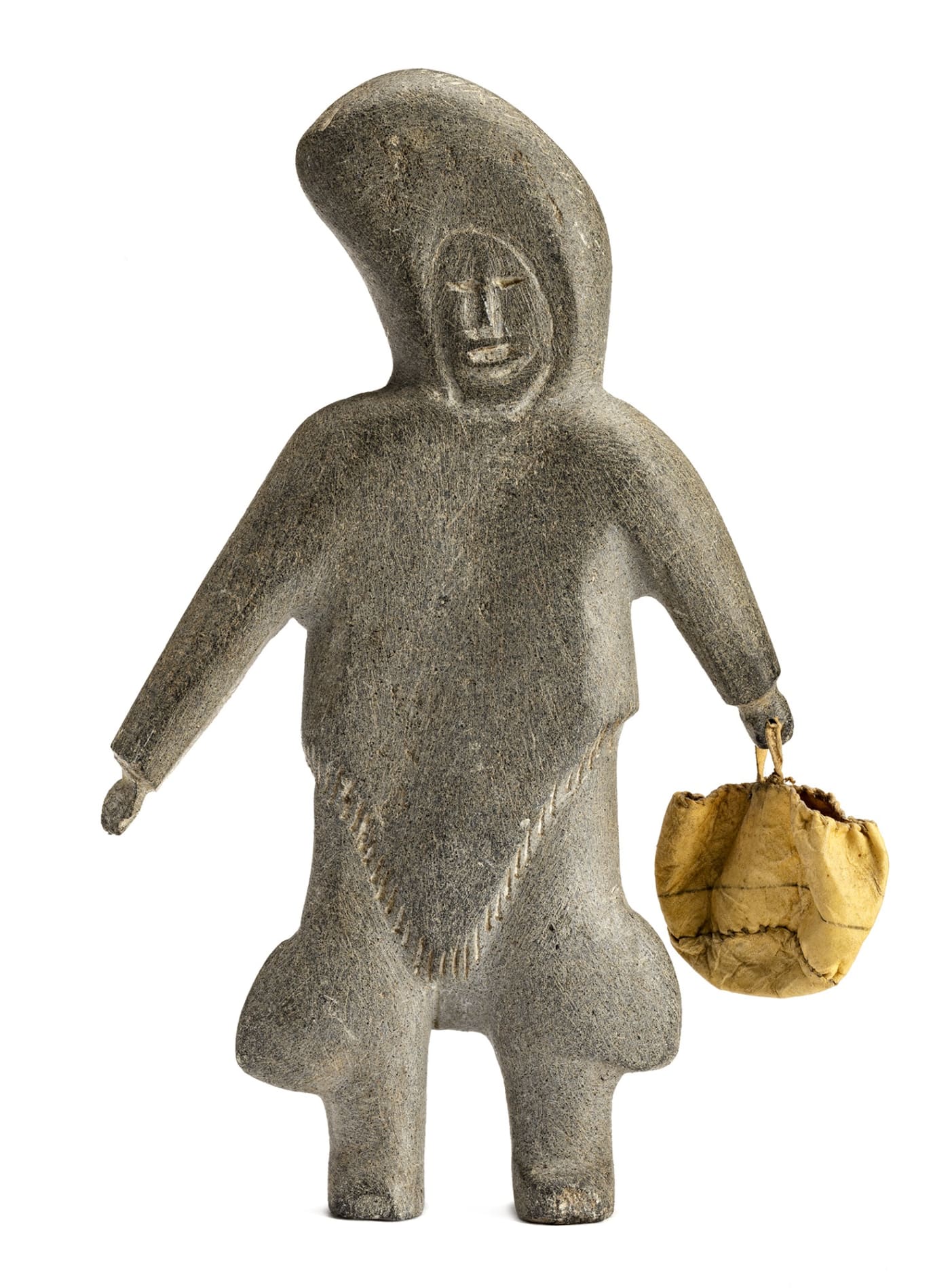 Lot 29 MARGARET UYAUPERQ ANIKSAK (1905-1993) ARVIAT (ESKIMO POINT) Standing Woman with Skin Bag, c. 1967-68 stone, skin, and sinew, 8.25 x 4.75 x 1.25 in (21 x 12.1 x 3.2 cm) Estimate: $1,200 — $1,800 Price Realized: $1,440