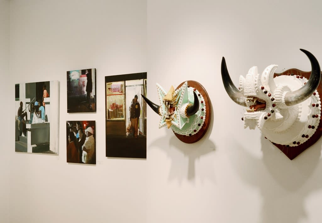 Art fair installation featuring sculptural work of Scott Hove in foreground and John Wentz figurative paintings in background 