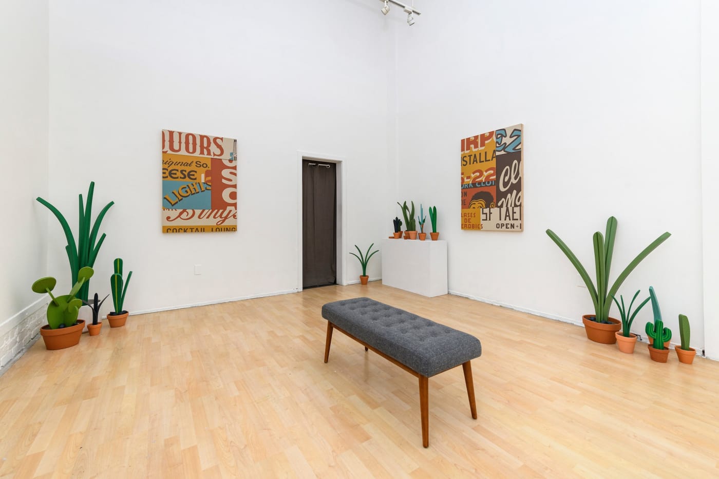 installation photos of Jeff Canham's show with plant sculptures and signs 