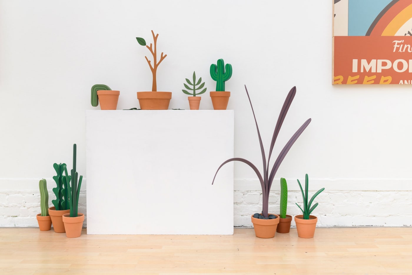 installation photos of Jeff Canham's show with plant sculptures and a sign