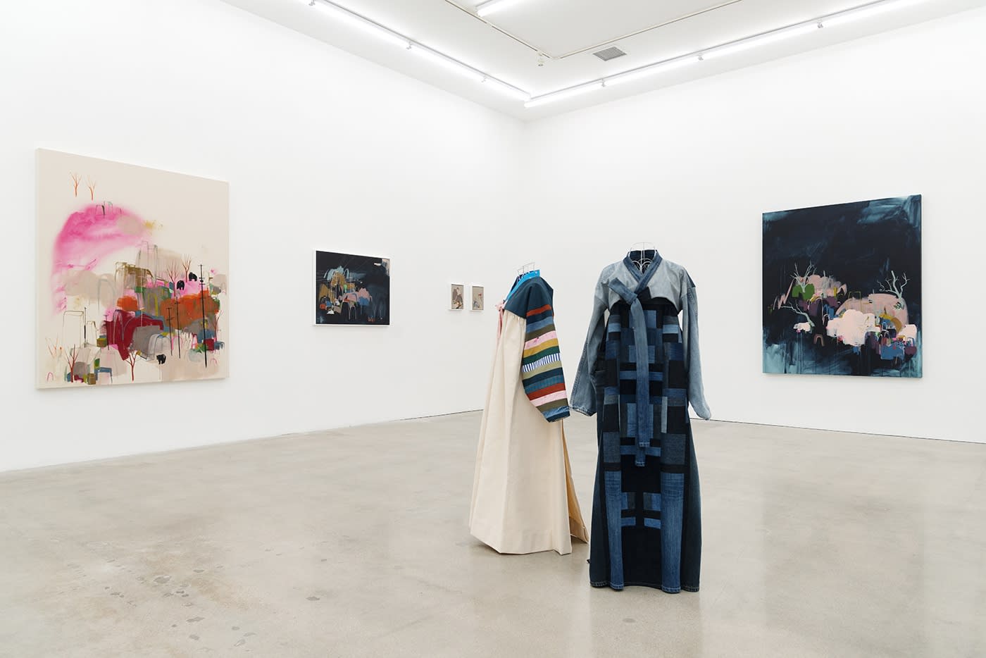 Seonna Hong at Hashimoto Contemporary Los Angeles installation view of hanbok in foreground, paintings in background