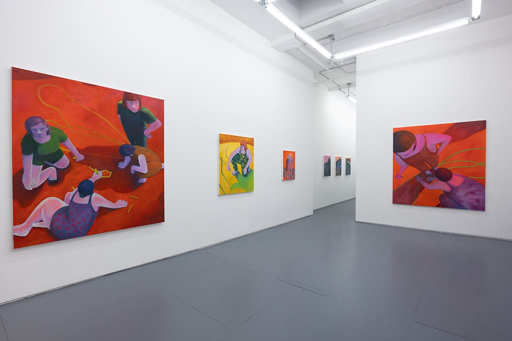 Installation image of red and yellow Genevieve Cohn paintings