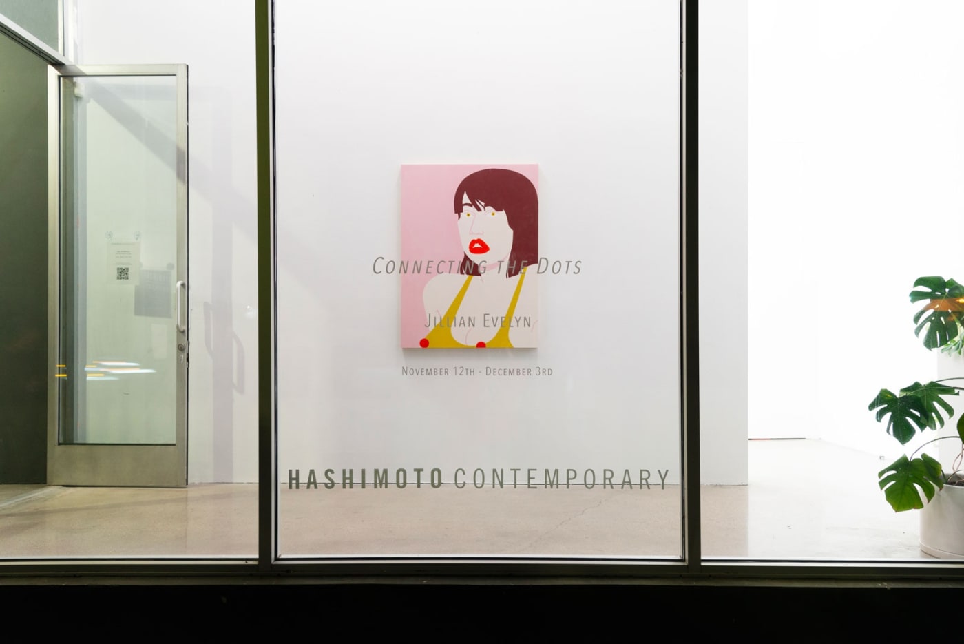 Installation shot of the gallery front window with show title and painting "Eyeful" on the wall behind the window.