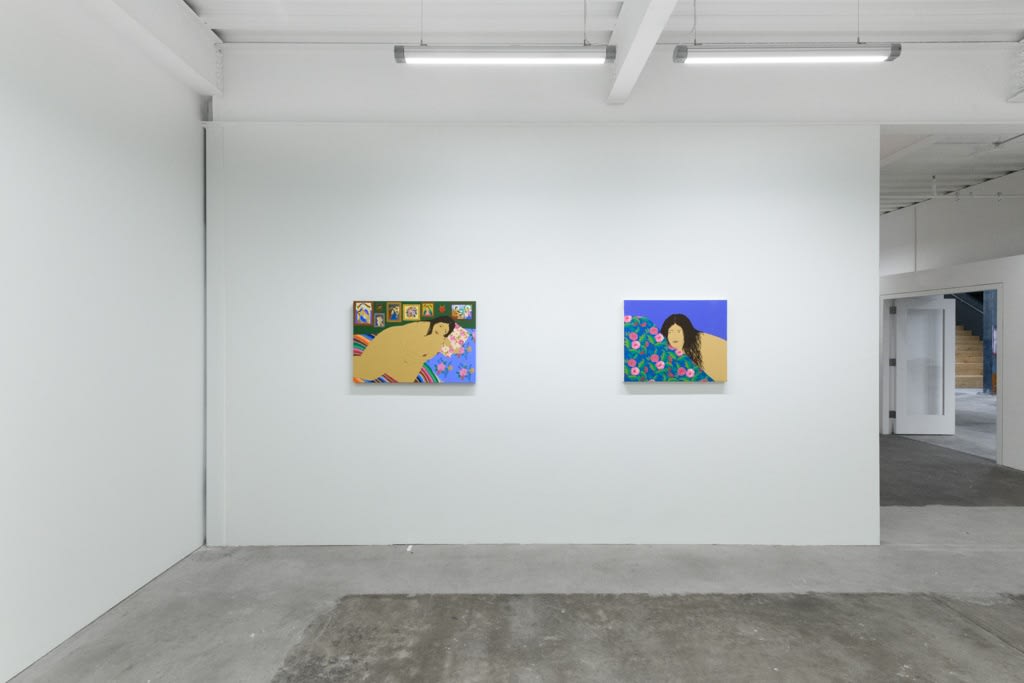 installation of Gina M. Contreras exhibition - two paintings of nude female figures with patterned blankets