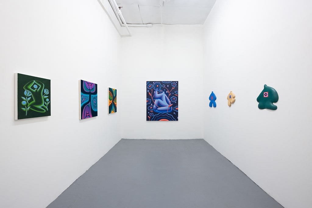 installation picture of Jocelyn Tsaih's "The Garden is Open" of various colorful paintings on three white walls