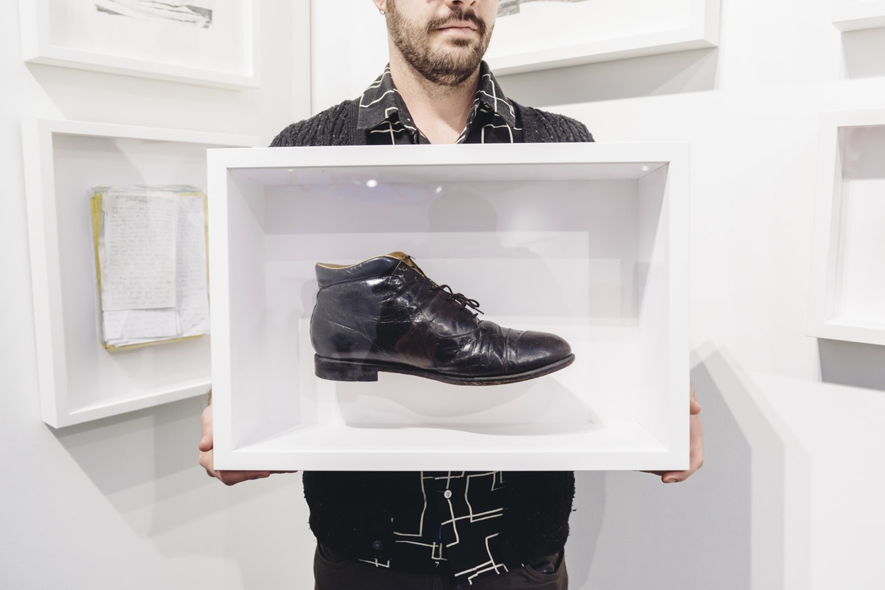 Portrait of artist Joel Daniel Phillips with his work