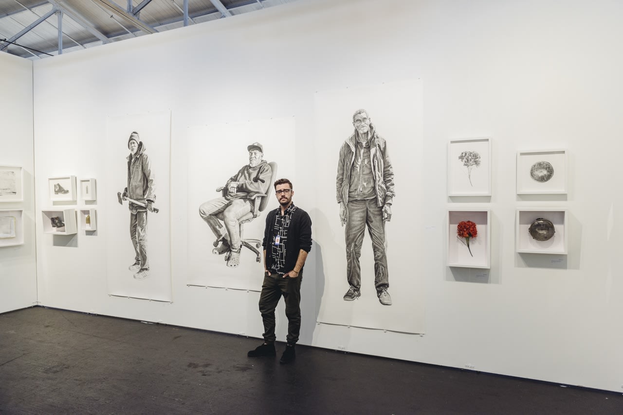 Portrait of artist Joel Daniel Phillips with his work