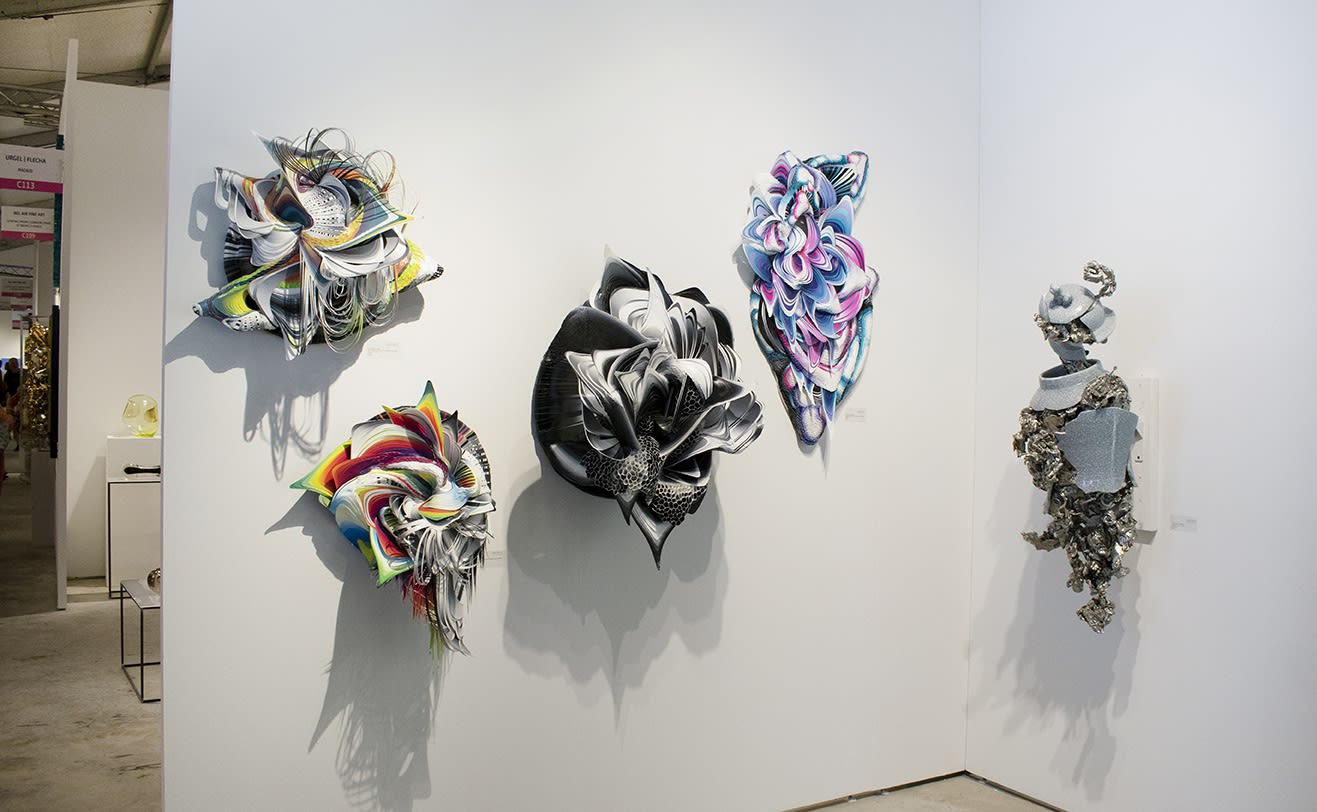 Crystal Wagner and Peter Gronquist work at CONTEXT: Art Miami