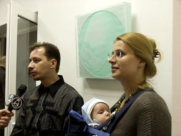 gallery owner Sergei Popov, collector Mikhail Popov, artist Alexandra Andreeva against the backdrop of the work of Vitaly Pushnitsky from the collection of Mikhail Popov