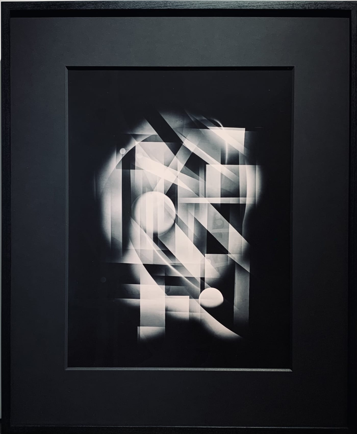 Michael G Jackson, representation of Central Park in New York City with abstract visual of Luminogram silver gelatin print in very unique way, like neon lights in the night, this is a uniqe fine art print, hand made in the darkroom, Framed with black moun