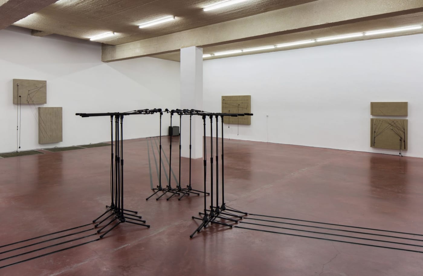 Naama Tsabar. Barricade #3, 2016, 12 microphones and microphone stands and matching audio equipment, 62 × 98 × 98 inches