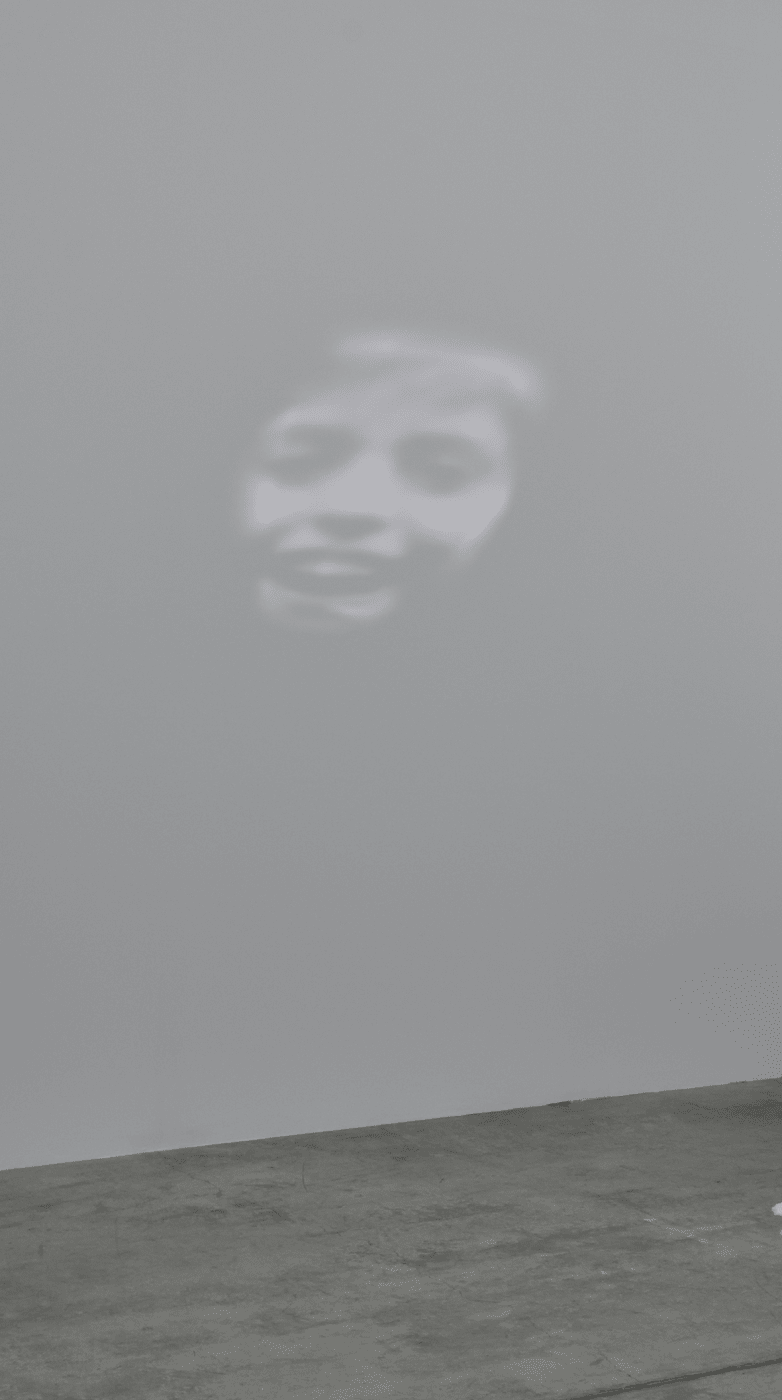 This installation is juxtaposed with projections on the walls titled Les Esprits (2020). In them we see the faces of...