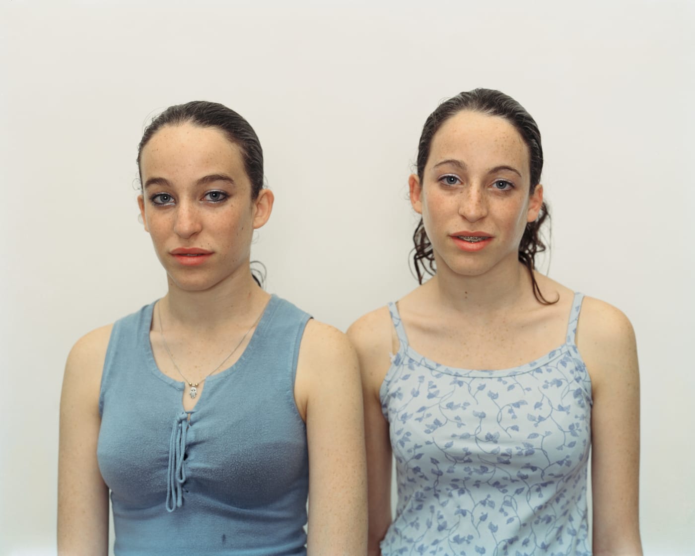 A Rineke Dijkstra portrait of teenage twin girls wearing blue shirts