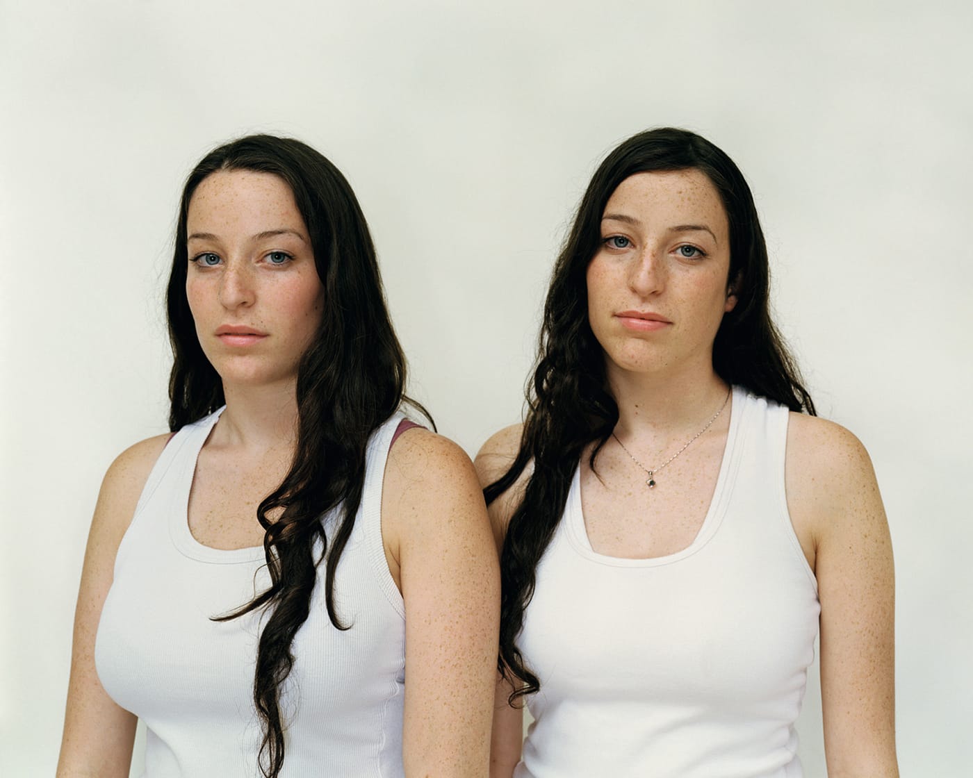 A Rineke Dijkstra photograph of twins Chen and Efret in matching white tank tops