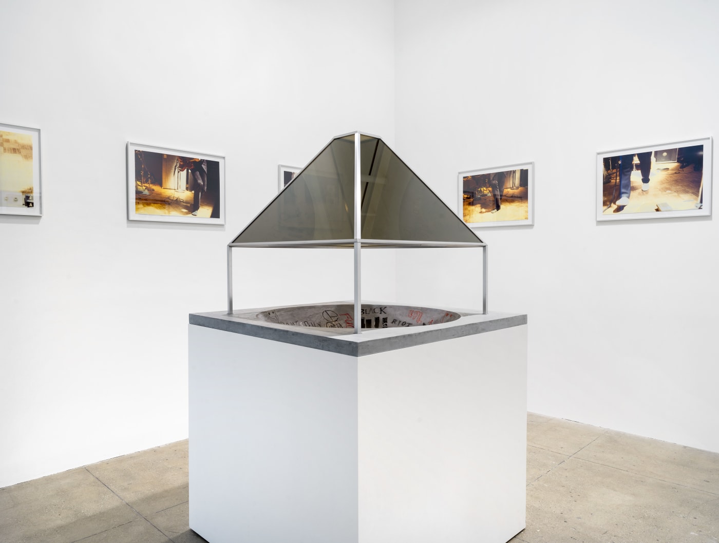 A skateboard Pavilion designed by Dan Graham with photos by Isa Genzken as installed at Marian Goodman Gallery New York