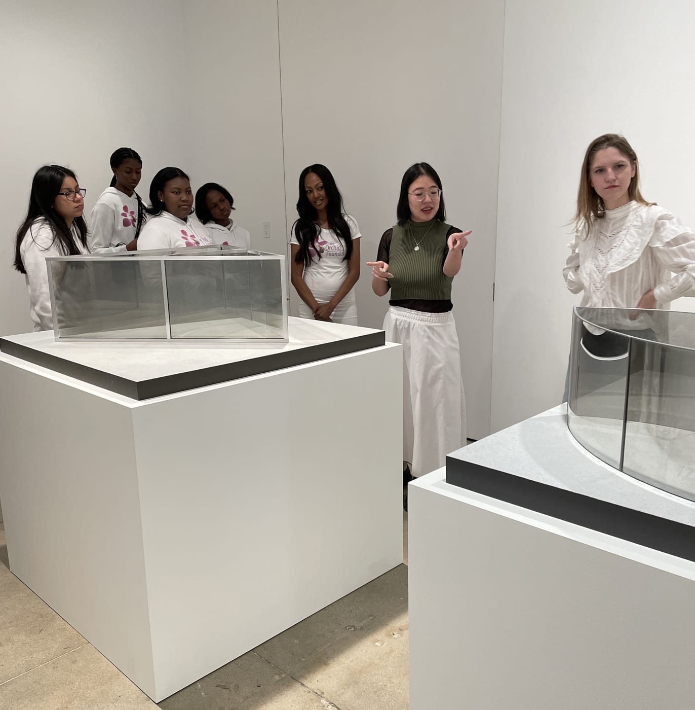 Students look at maquettes made by Dan Graham