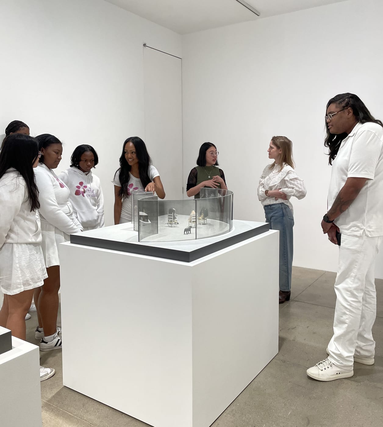 Students look at maquettes made by Dan Graham