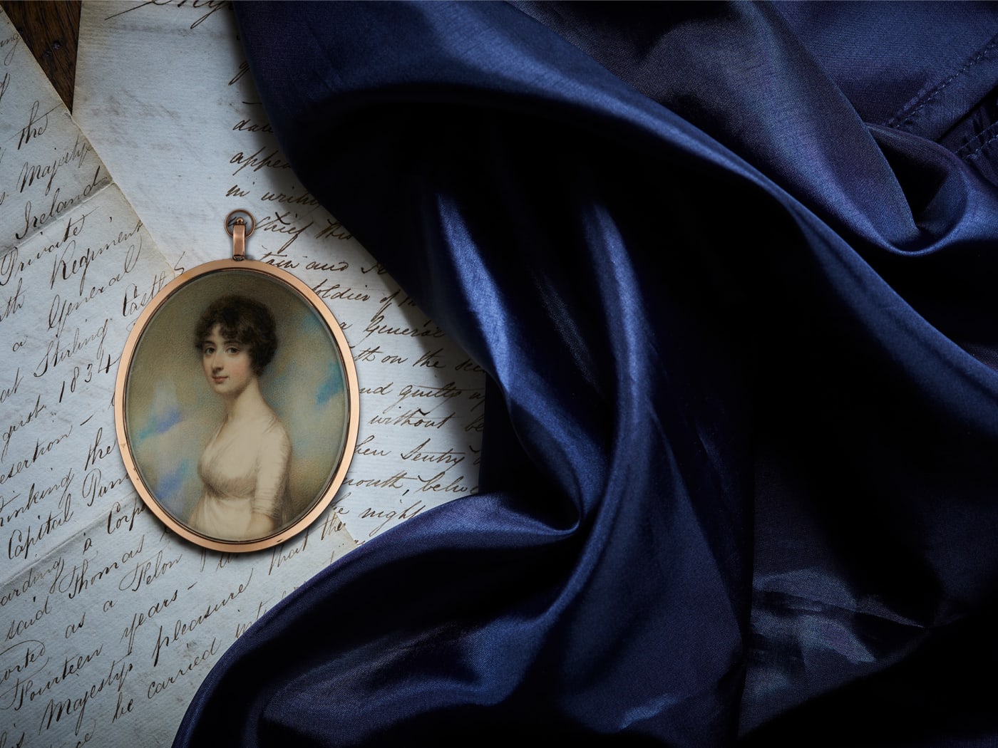 portrait miniature of Jane Austen's brother's wife displayed on hand written letters and blue fabric