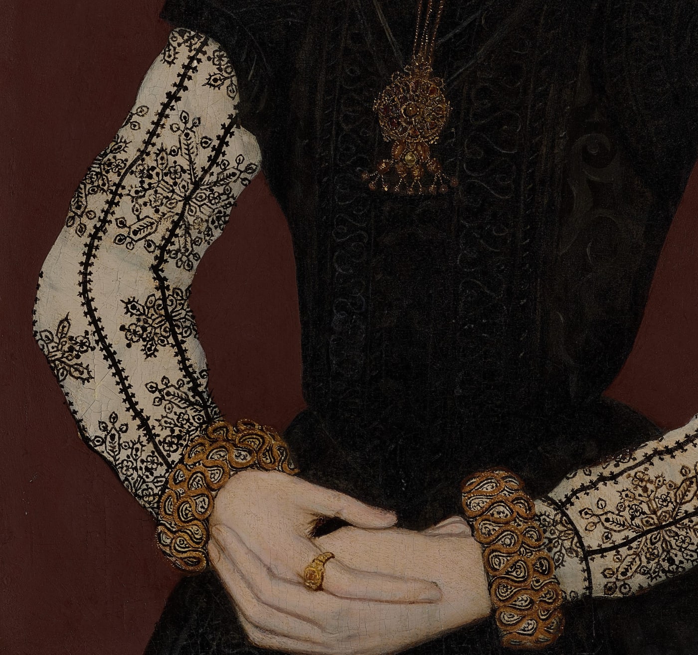 clasped hands of young woman dressed in embroidered dress painted by a tudor artist