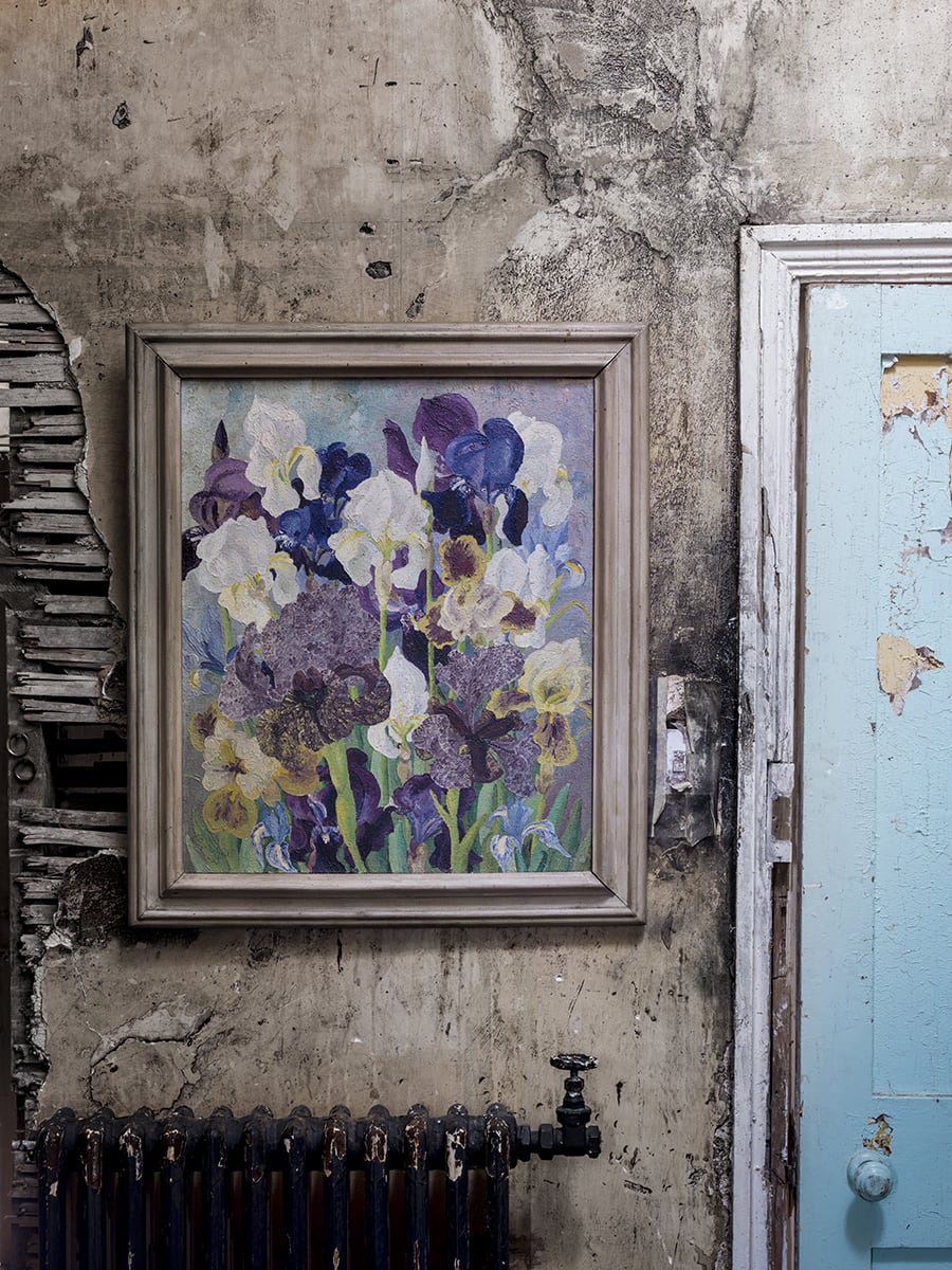 Cedric Morris painting of flowers and irises in a shabby chic interior next to a blue door