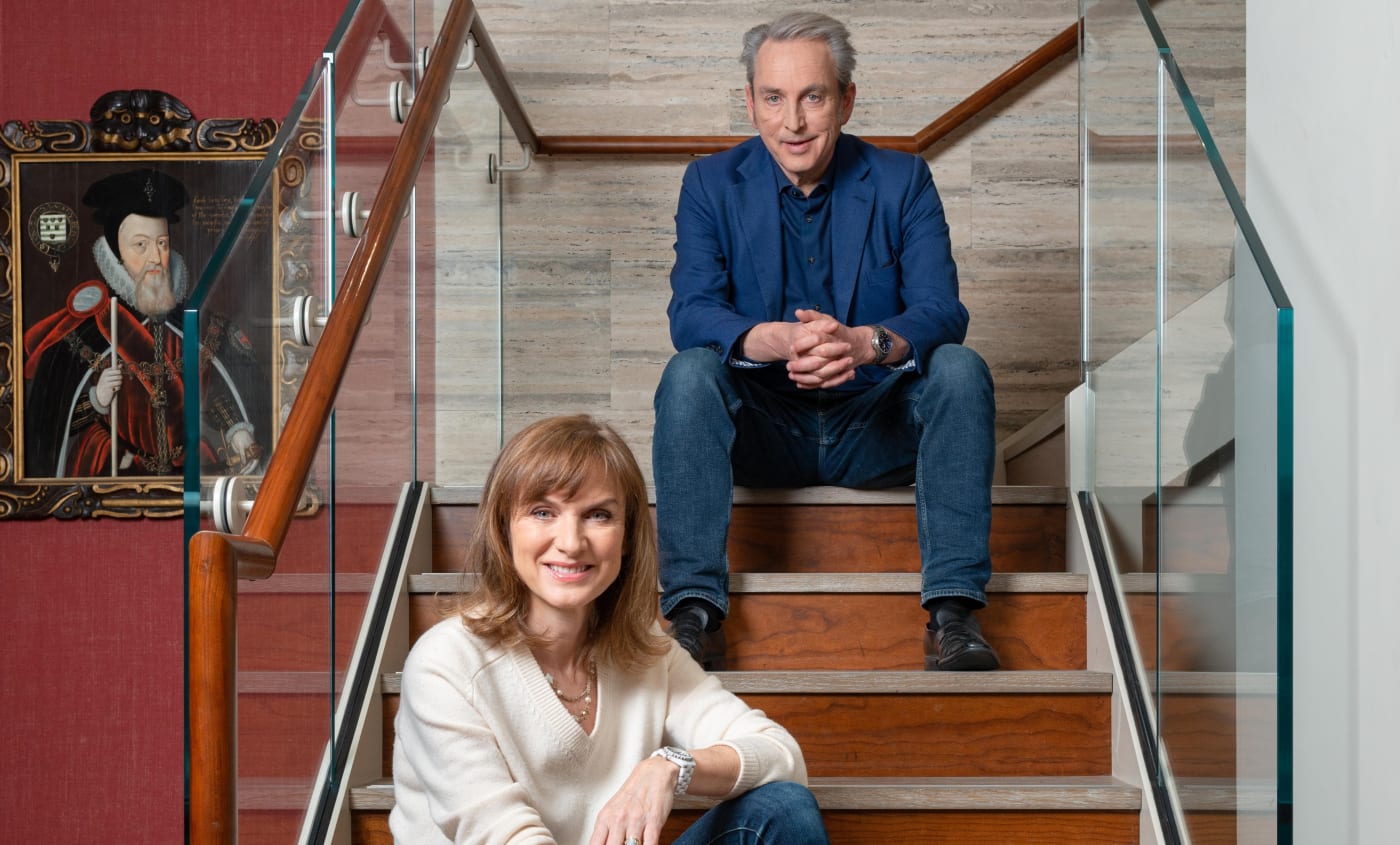 fiona bruce and philip mould sitting on a set of stairs