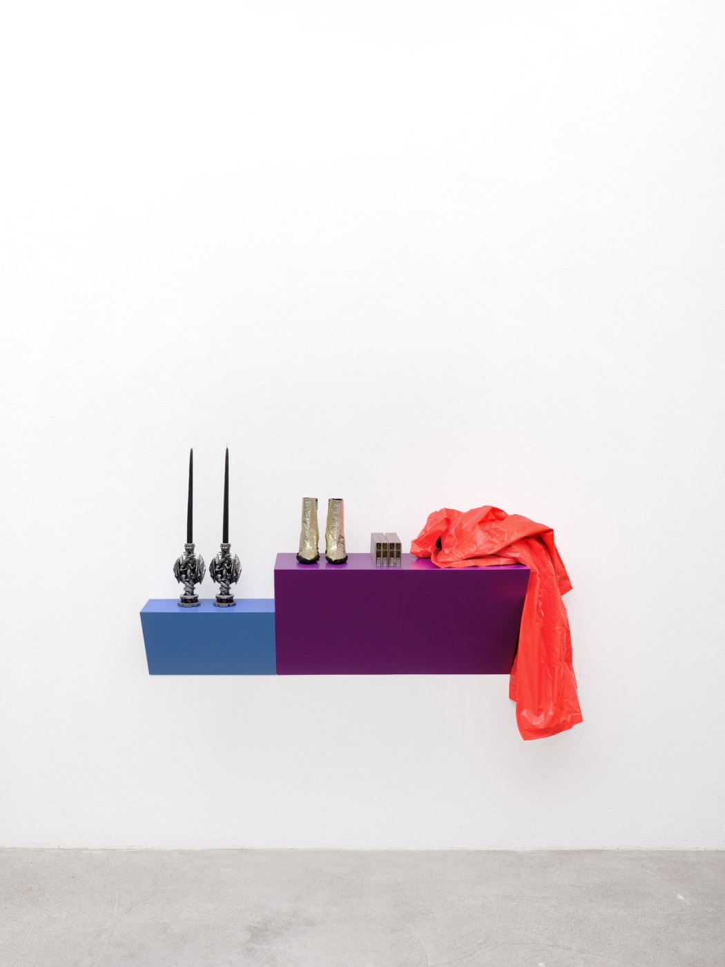 Sylvie Fleury Treasurer, 2023 Wood shelf, 2 candle holders, muddy gold boots , 2 cartons of cigarettes, rain coat 48.5...