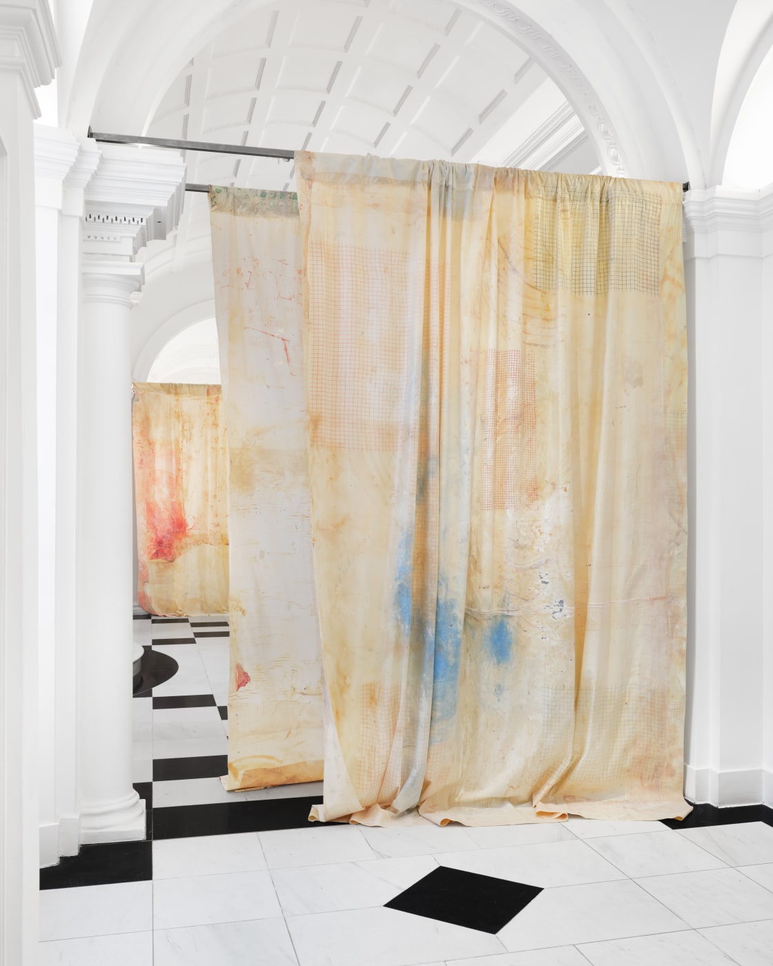 Brushed, smeared, splattered and screenprinted with peach, blood-red and bruised-blue paint, skin-like latex curtains are suspended from the ceiling of...